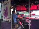 The "Pink Bus" sends riders a mixed-message: Adorned with pink fringe curtains, an angel on the dashboard and pink-fringed Virgins of Guadalupe all over the ceiling...but what
