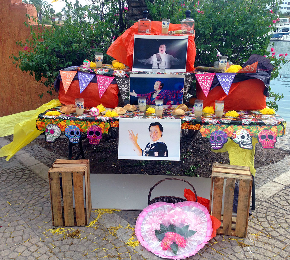 Most businesses and homes in Mexico set up shrines to honor their deceased loved ones during Dia de Los Muertos. This particular shrine was set up on the malecón at the marina in front of one of the restaurant/bars, and was to commemorate the founder of one brand of tequila!
