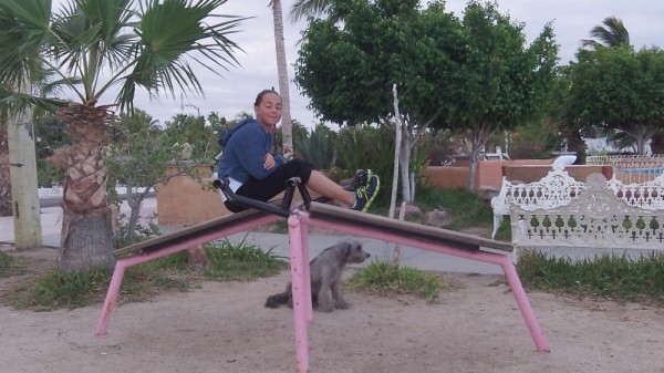Sydney doing crunches at local outdoor gym with "Lexie" waiting patiently.