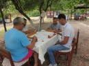 The men sharing a game under the trees
