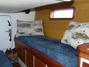 Aft cabin, port side.  Two sea bunks, guest quarters.  Cramped but useful. Unused door to the engine room.