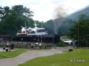 The Jacobite Steam train passes along the West Highland Railway past the Lord of the Glens cruise ship.
