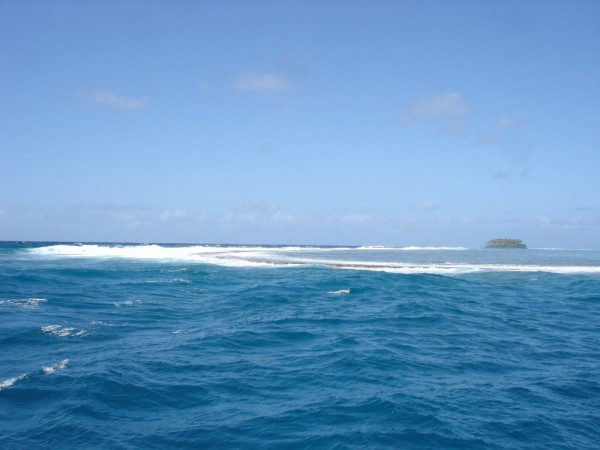 Passe Teavamoa along the east side of Raiatea Island.  This is the south side of the pass.  Waves crashing into the reef.