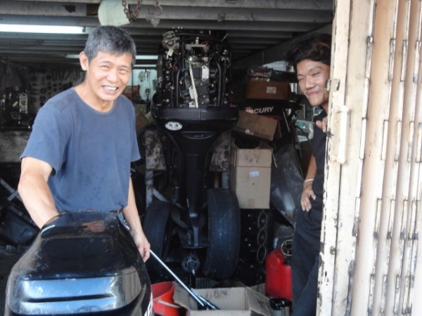 The manager of the store with one of the mechanics
