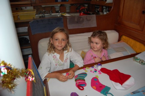 Lily and Kara examine their stockings on Christmas morning aboard Magnum