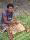 local village woman weaving basket