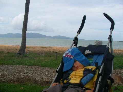 Joe asleep on the Strand (Magnetic island in distance)