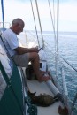 Ron and the cats try the shady side of the boat on our crossing.  