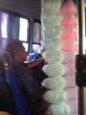 A typical "autobus" scene with a vendor and his cotton candy, likely traveling to a beach to sell for the day.  