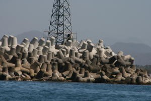 The jetty separating the ocean with the municipal harbor (where the cruise ships go in and where we anchored).  They must have run out of rocks so they made their own.  The concrete "rocks" looked like giant jacks (kid toy).
