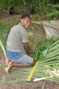 2) This is Tui weaving cooking baskets around the fish and taro that would go into the lovo pit.