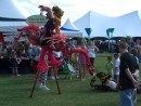 A stilt puppet performing for the crowd at the festivities