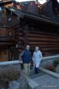 Jim and Jeannie outside their log cabin.