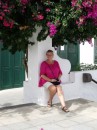Sue trying to look camouflaged beside colourful Bougainvillea.