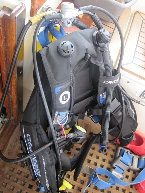 Rigging dive equipment to scrub off the hull below the waterline