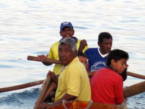 Some of the local fishermen in their dugout canoe.