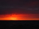 Sunset backdrop to Rapau under sail.