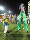 Sue dances with stilt walkers