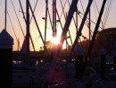 Sunset through the rigging of vessels at Bayona.