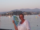 A Senora keeping cool during her promenade. Bayona, looking inland across the harbour to the Galician mountains.