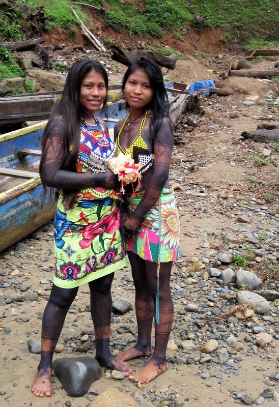 Two beautifully decorated Embera women come to welcome the group to the village.