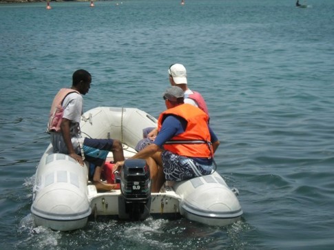 Menno helps Nick teach the sailing class. He drives the rescue dinghy.JPG