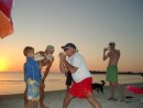John, Menno and Paul blowing conch horns at sunset.