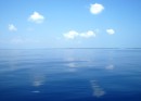 Belize – On our way to Belize with absolutely no wind! You can make out the small Cay on the horizon, Belize is full of hundreds of them and surrounding all of them are shallow waters and reefs. Pretty as they are to look at they are hazards to sailboats. 