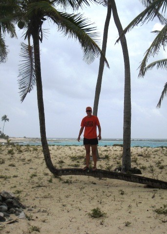 Half Moon Cay – Heather standing on a palm that decided to grow horizontal to the ground before turning to grown straight up. 