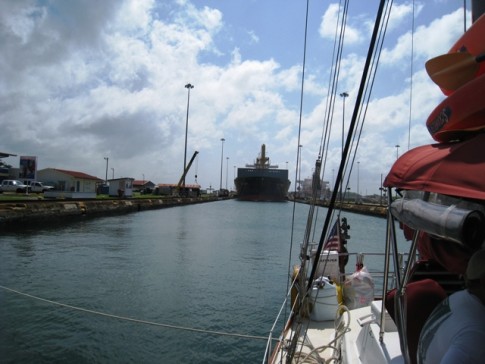 Canal Transit – We are at the front of the Gatun lock with a ship behind approaching within the lock. 