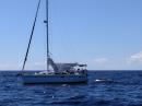 Faith Afloat hove to in the Exuma Sound: You might see Luke off the stern
