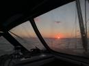 Sunset through a salt-encrusted window.: Pretty much the whole boat is covered with salt.
