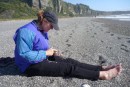 Alison on rocky Punakaiki beach, sifting through tiny, beautiful rocks. (It