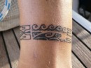 Michael on Paikea Mist sports a new tattoo by artist Brice in Taiohae Bay on Nuku Hiva. The motif includes a whale, just below the waves, symbolic of Paikea Mist.