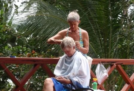 Lisa Choquette, dive master extraordinaire, does double duty giving Katie a haircut. 