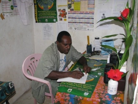 Nurse in his office (that has no lights) at Loltong Dispensary