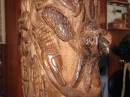 A small parrot peeks from the hole Del carved in the nub on the tree