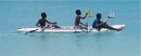 Three boys and two sailboats in Road Bay, Anguilla.