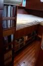 Aft Cabin bookshelves: When we made the bunk wider, we added book shelves and storage