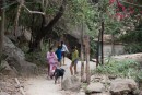 Some kids out playing on the path to the waterfall.