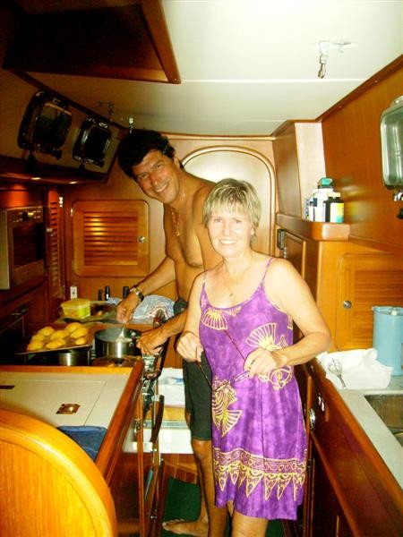 Mike and Linda making Chistmas dinner aboard Aquila there Hylas 49