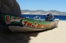 This boat brings the beer and umbrellas to Lovers Beach each day.