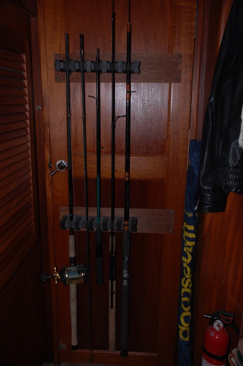 Fishing rod holder on the state room side of the salon door. This is off center to the left in order to allow it to miss the wood work that surrounds the mast