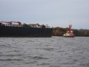 Another tug towing a barge...but how does it stop it?