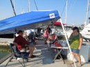 The potluck is set up on the dock for the Texas Mariners Cruising Association. Scott and Tamara are in front.
