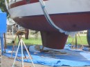 Bud finishes painting the bottom of the keel while Earendil hangs in the slings
