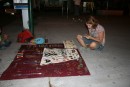 Katryn inspecting handmade jewelry
