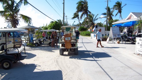 Barefoot Man crossing the street and a golf cart celebrating Barefoot Man