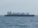 Ship carrying LNG in Darwin Harbour, escorted by warship