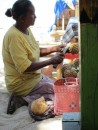 Woman carving pineapple